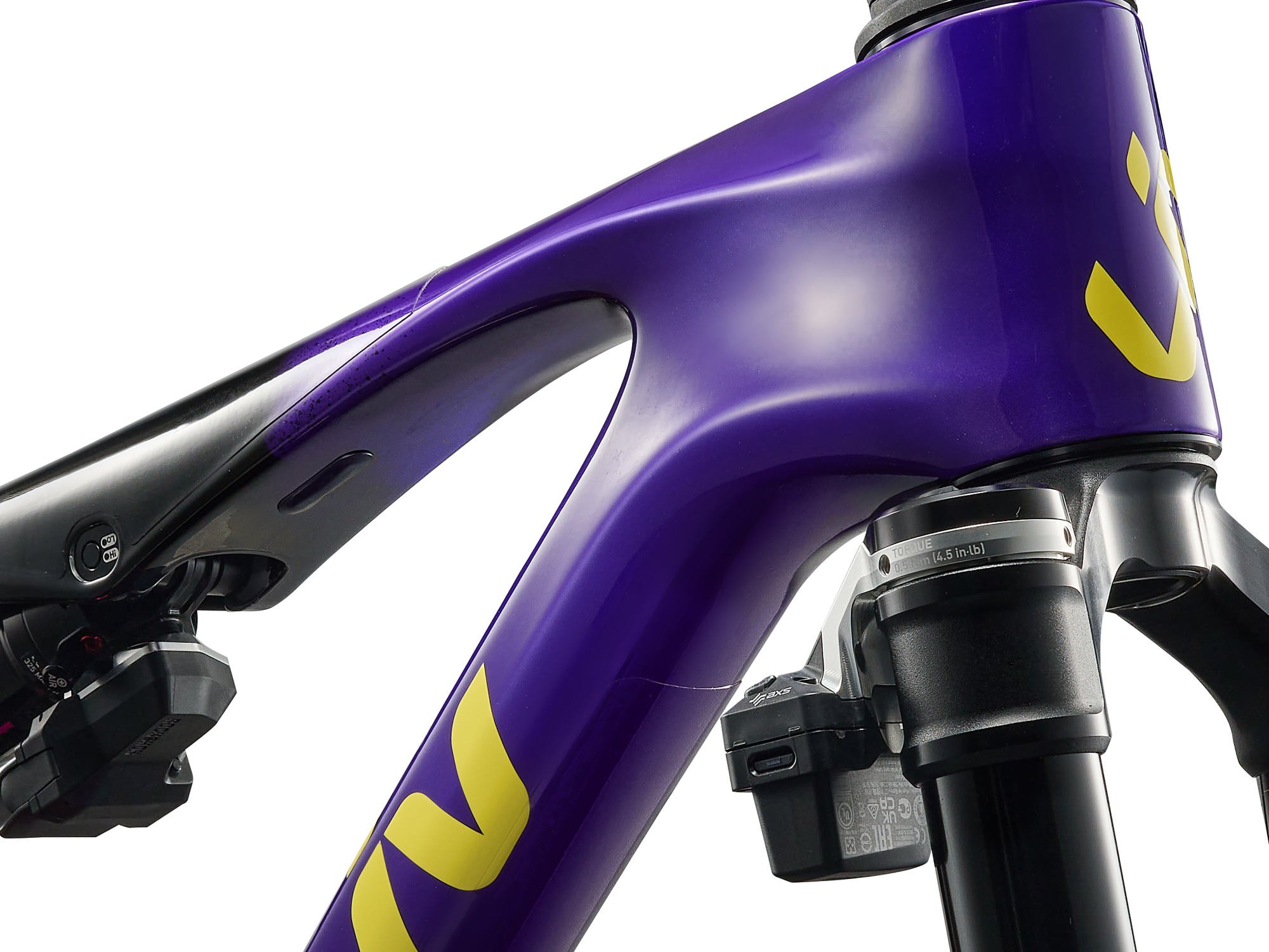 Detailansicht des Steuerrohrs am Liv Pique Advanced SL – violetter Carbon-Rahmen mit gelbem Liv-Logo und integrierter Kabelführung